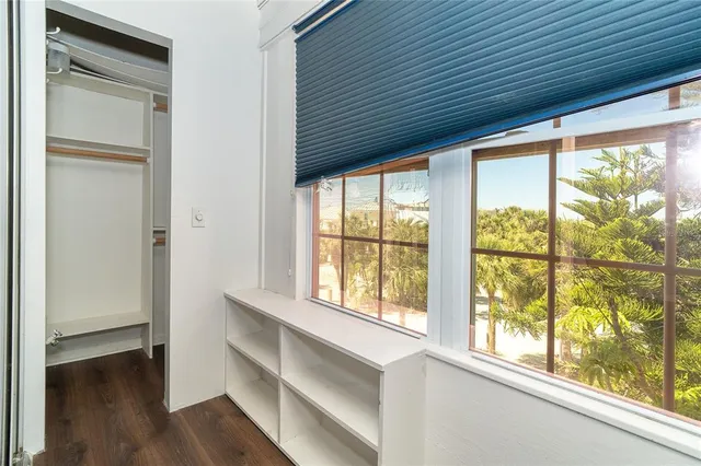 a view of room with window and wooden floor