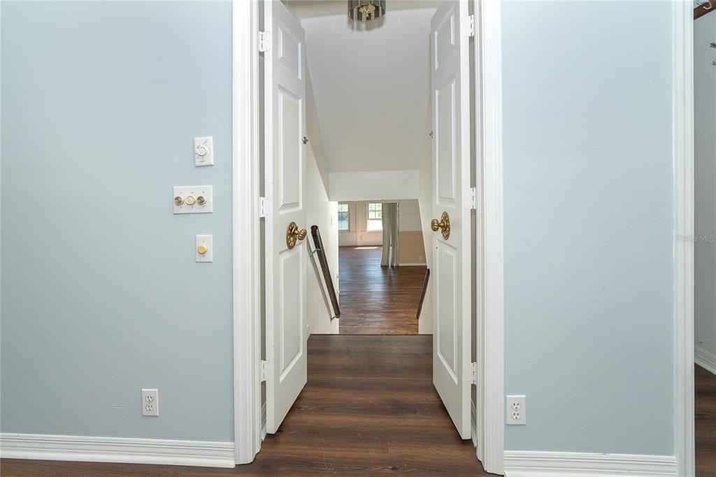 20 Palm Drive Placida, FL 33946 - Photo 38 of 46 a view of a hallway with wooden floor and staircase