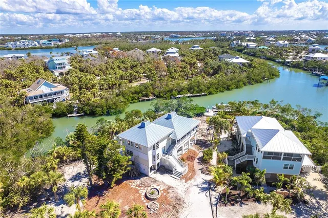 an aerial view of residential houses with outdoor space and river