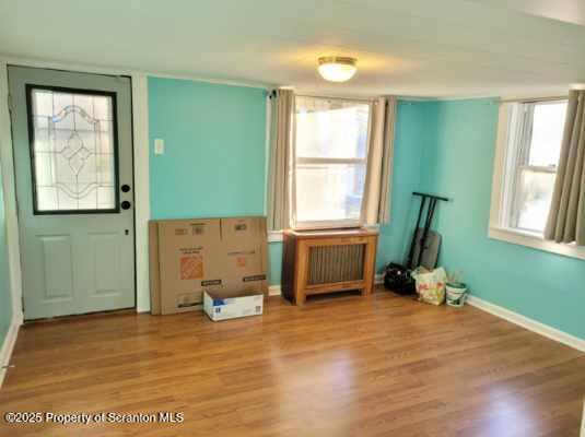 430 Salem Road Archbald, PA 18403 - Photo 4 of 19 an empty room with a window and wooden floor