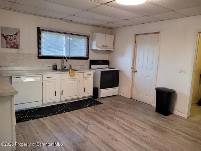a view of a kitchen with electric appliances
