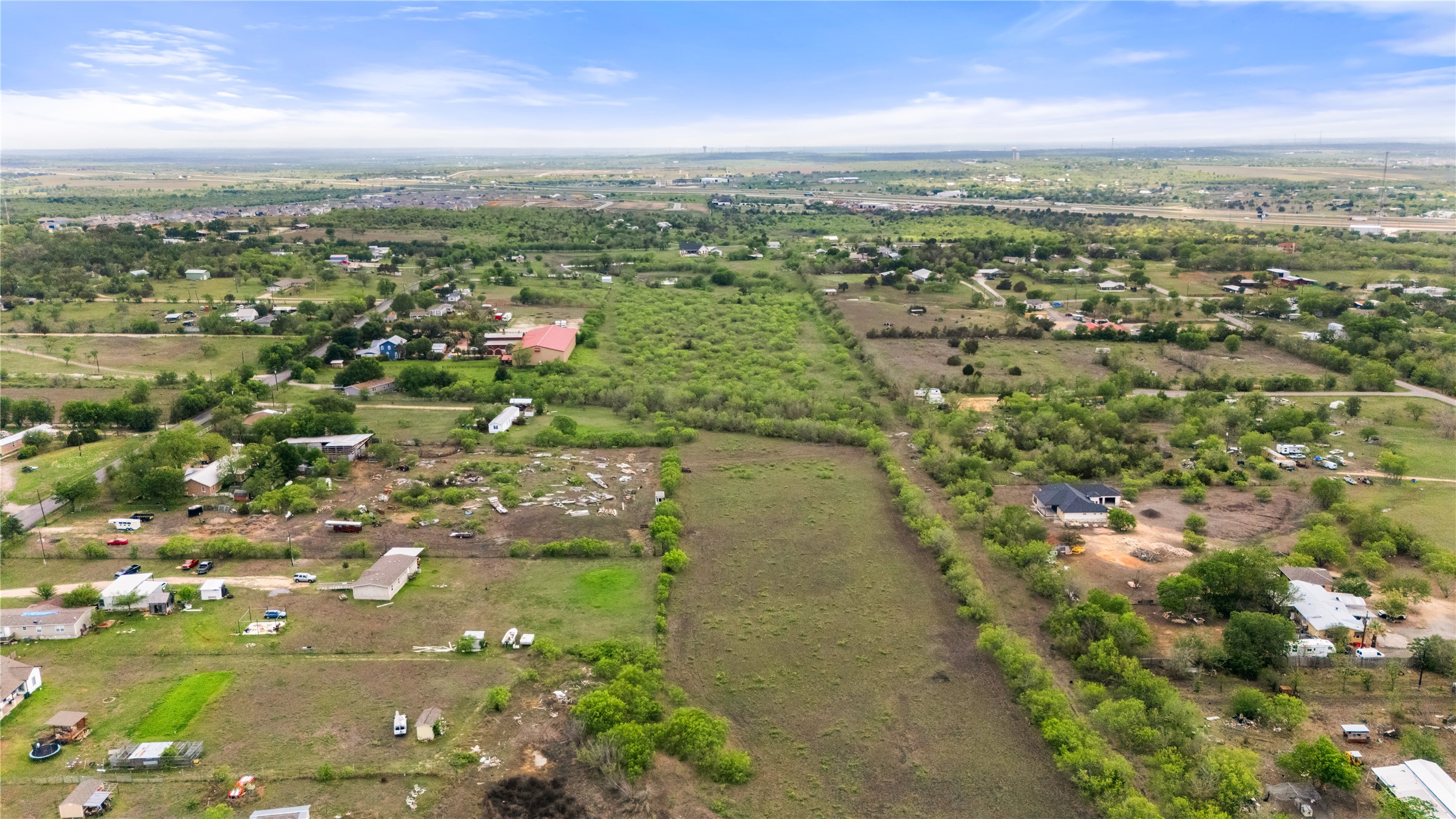 8802 Evelyn Road Buda, TX 78610 - Photo 10 of 13 Expansive land parcel featuring a mix of open fields and natural tree coverage