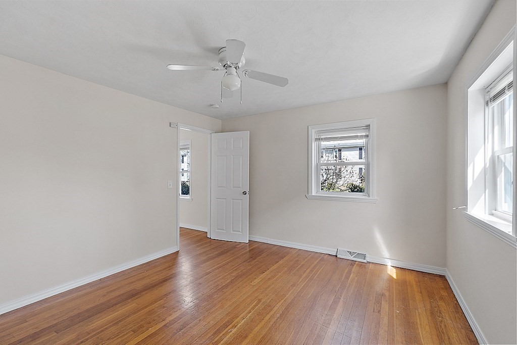 10 Vecchia Street, Unit C Webster, MA 01570 - Photo 12 of 29 an empty room with wooden floor and windows