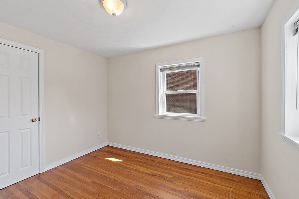 10 Vecchia Street, Unit C Webster, MA 01570 - Photo 17 of 29 a view of an empty room with wooden floor and a window