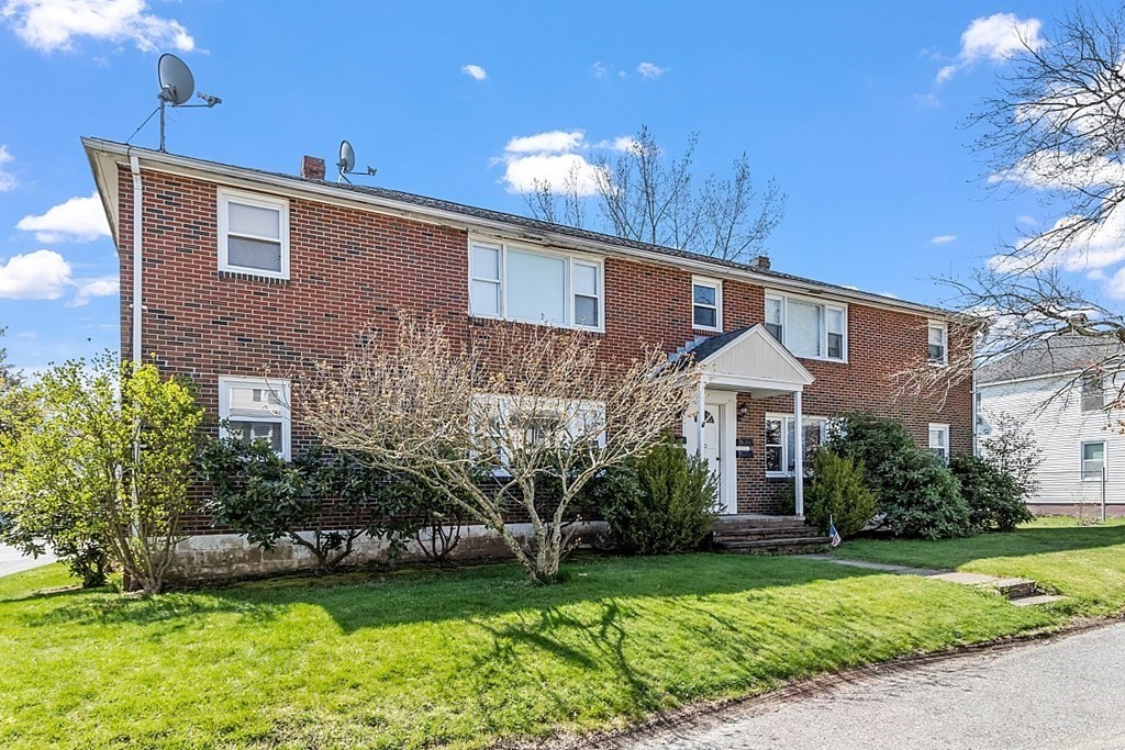 10 Vecchia Street, Unit C Webster, MA 01570 - Photo 22 of 29 a front view of a house with a garden and plants