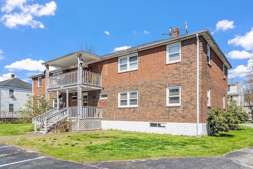 10 Vecchia Street, Unit C Webster, MA 01570 - Photo 27 of 29 a front view of a house with a yard