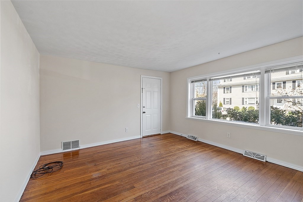 10 Vecchia Street, Unit C Webster, MA 01570 - Photo 3 of 29 a view of an empty room with wooden floor and a window