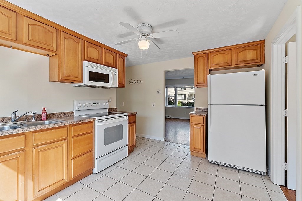10 Vecchia Street, Unit C Webster, MA 01570 - Photo 8 of 29 a kitchen with a refrigerator sink and cabinets