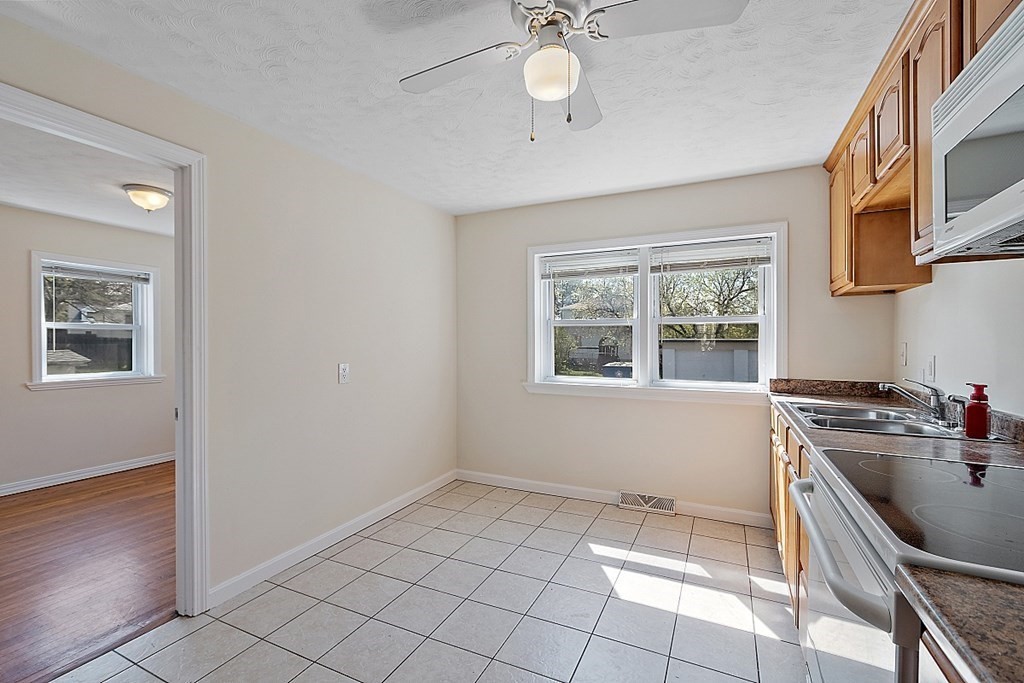 10 Vecchia Street, Unit C Webster, MA 01570 - Photo 9 of 29 a kitchen with a sink a stove cabinets and a window