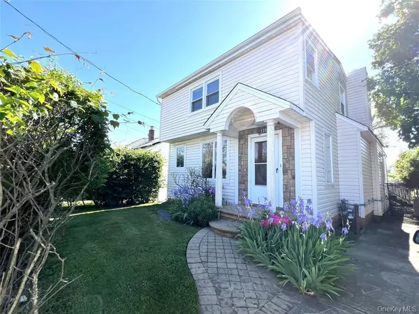 a front view of a house with a garden