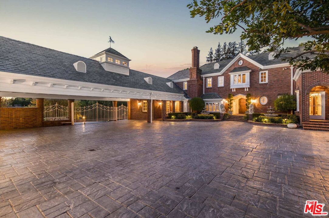 25045 Jim Bridger Road Hidden Hills, CA 91302 - Photo 13 of 52 a front view of a house with a yard