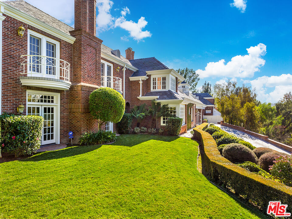 25045 Jim Bridger Road Hidden Hills, CA 91302 - Photo 15 of 52 a front view of a house with garden