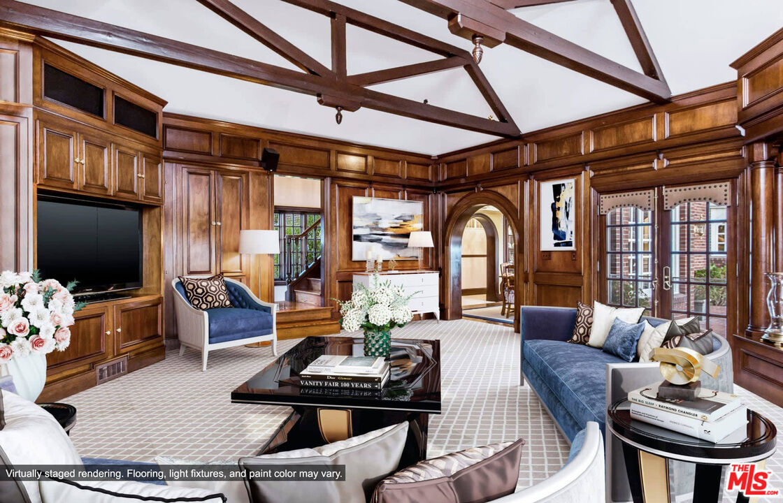 25045 Jim Bridger Road Hidden Hills, CA 91302 - Photo 26 of 52 a living room with furniture a flat screen tv and a floor to ceiling window