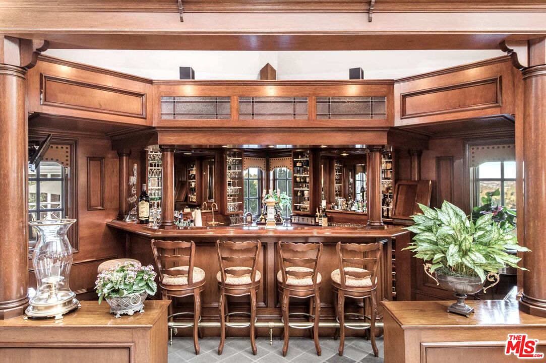 25045 Jim Bridger Road Hidden Hills, CA 91302 - Photo 28 of 52 a view of a dining room with furniture and chandelier