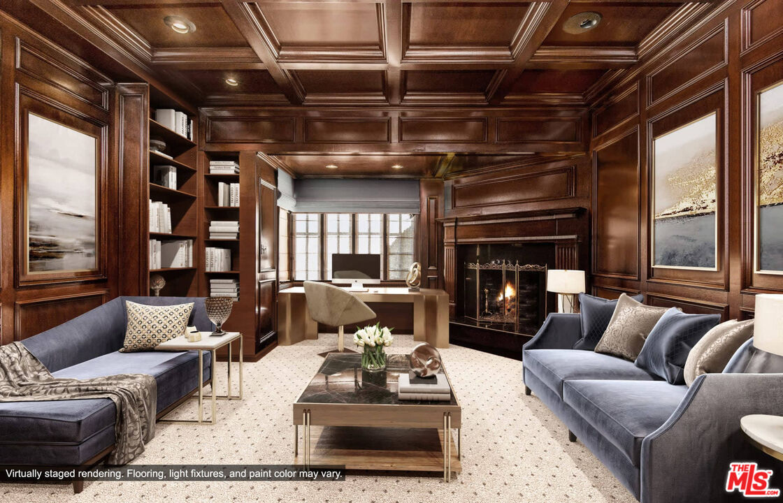 25045 Jim Bridger Road Hidden Hills, CA 91302 - Photo 29 of 52 a living room with furniture a ceiling fan and a fireplace