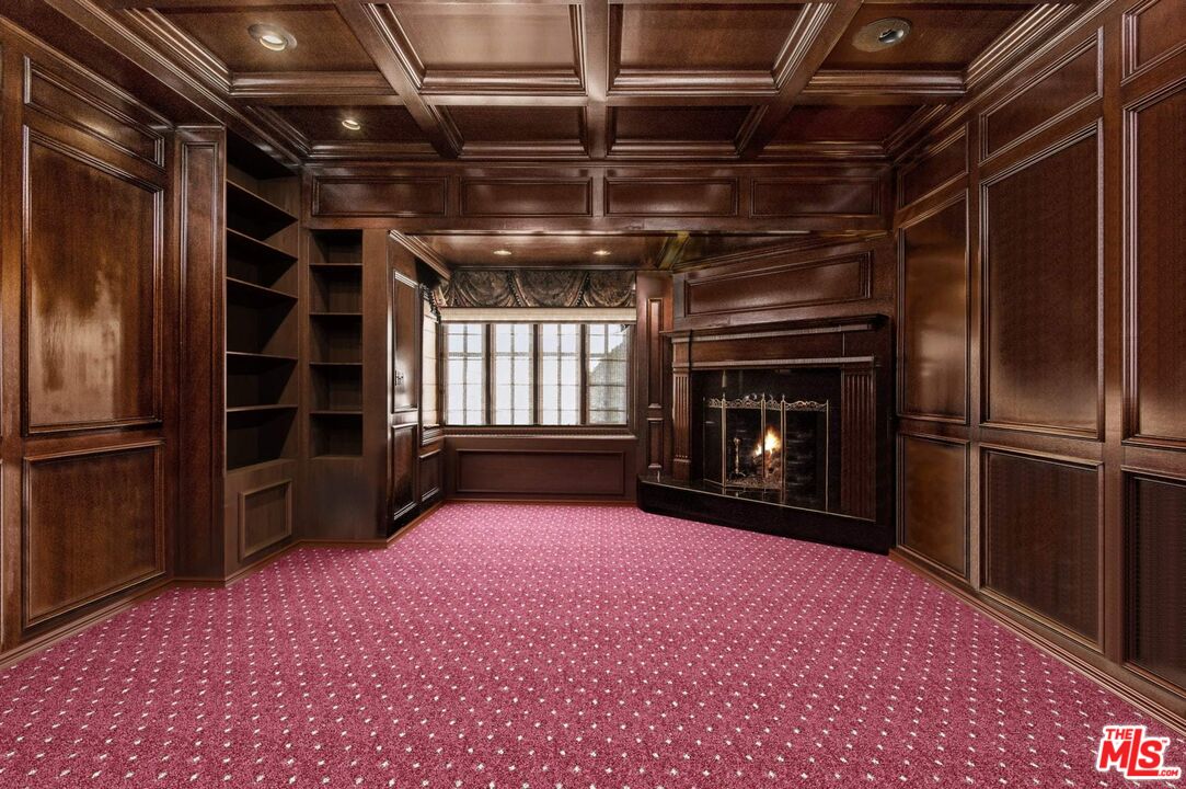 25045 Jim Bridger Road Hidden Hills, CA 91302 - Photo 30 of 52 a view of an empty room with a fireplace and a window