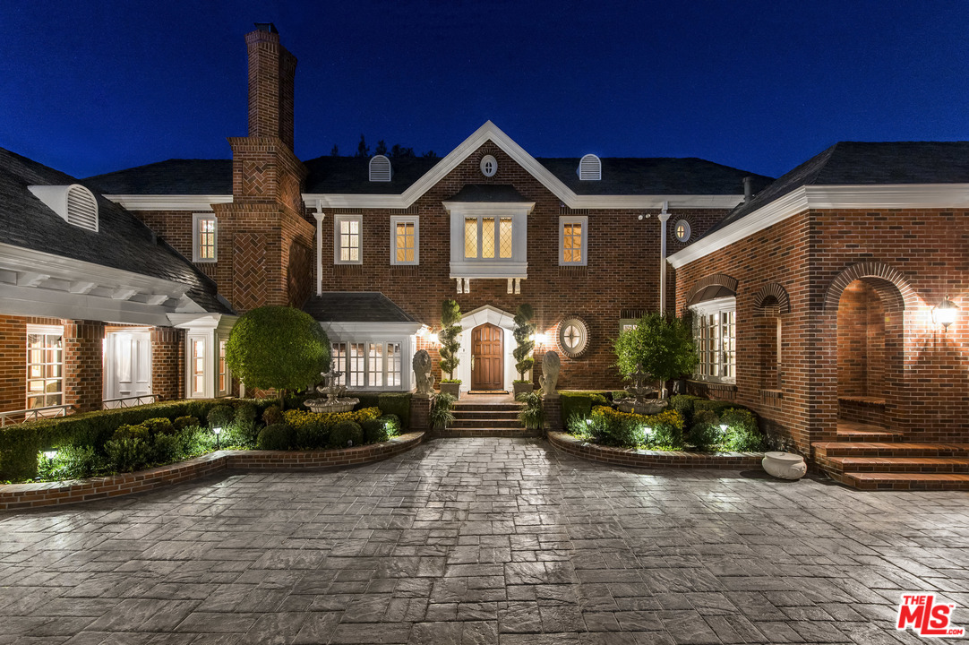25045 Jim Bridger Road Hidden Hills, CA 91302 - Photo 3 of 52 a front view of a house with a yard