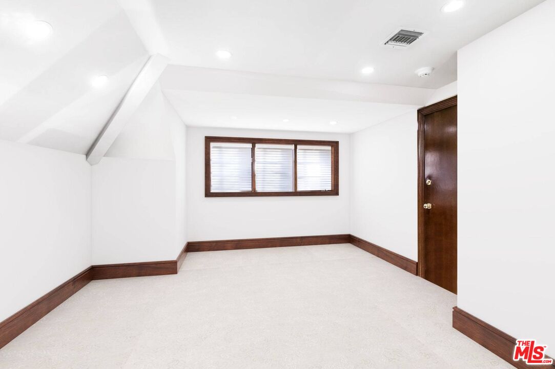 25045 Jim Bridger Road Hidden Hills, CA 91302 - Photo 40 of 52 a view of an empty room with a window