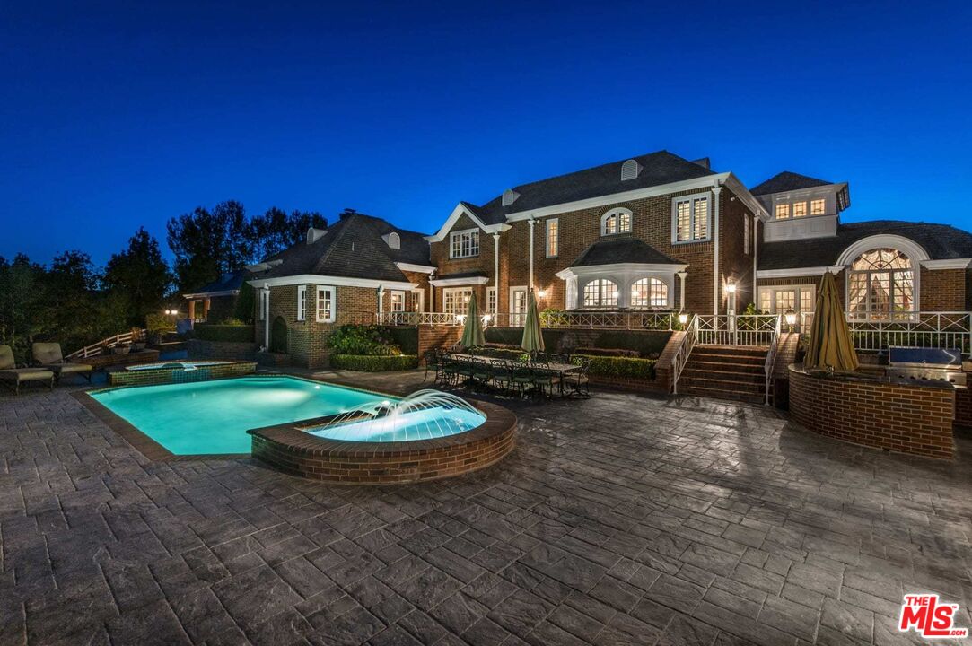 25045 Jim Bridger Road Hidden Hills, CA 91302 - Photo 43 of 52 a front view of a house with garden