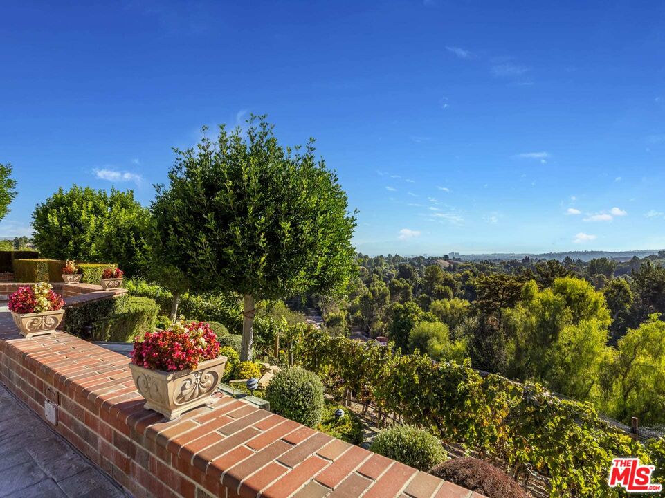 25045 Jim Bridger Road Hidden Hills, CA 91302 - Photo 47 of 52 a view of a chairs and table in the patio