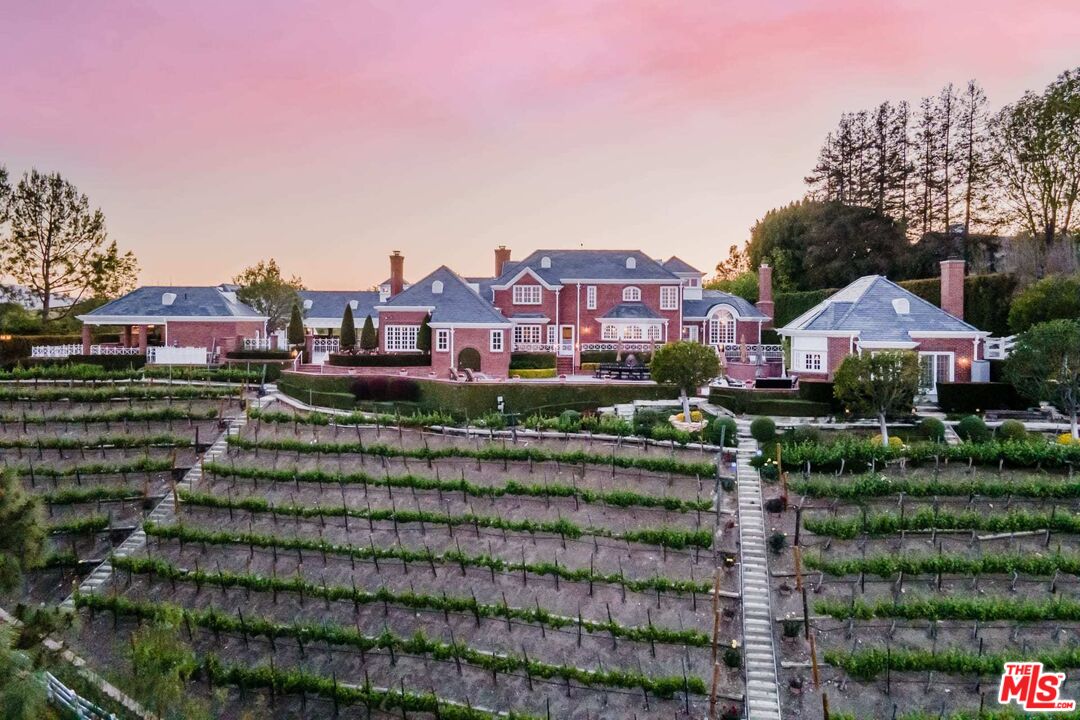 25045 Jim Bridger Road Hidden Hills, CA 91302 - Photo 5 of 52 a front view of a house with a yard and staircase