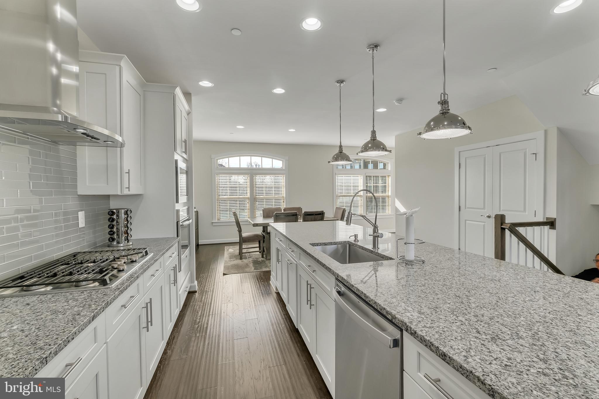 2918 Middleham Court Hanover, MD 21076 - Photo 11 of 37 a large kitchen with granite countertop a stove a sink a refrigerator and a wooden cabinets