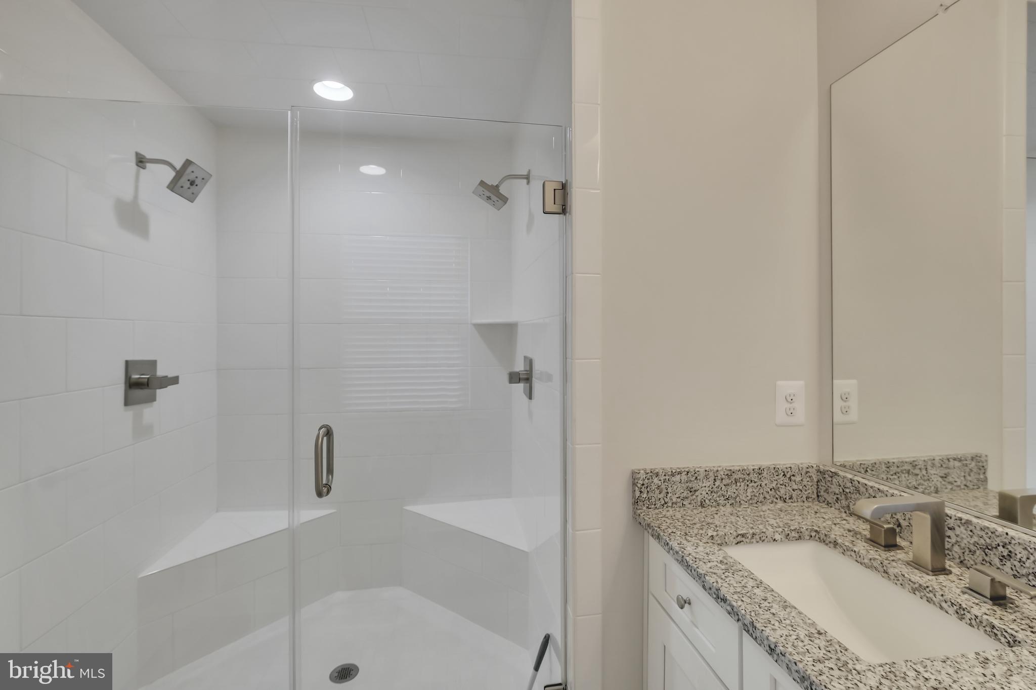 2918 Middleham Court Hanover, MD 21076 - Photo 15 of 37 a bathroom with a granite countertop sink a mirror bathtub and shower