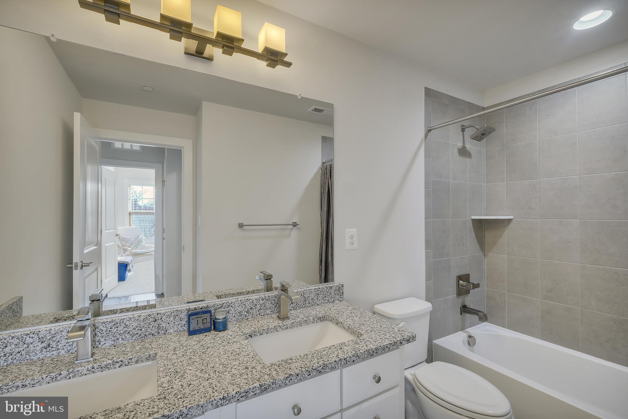 2918 Middleham Court Hanover, MD 21076 - Photo 19 of 37 a bathroom with a granite countertop sink toilet and shower