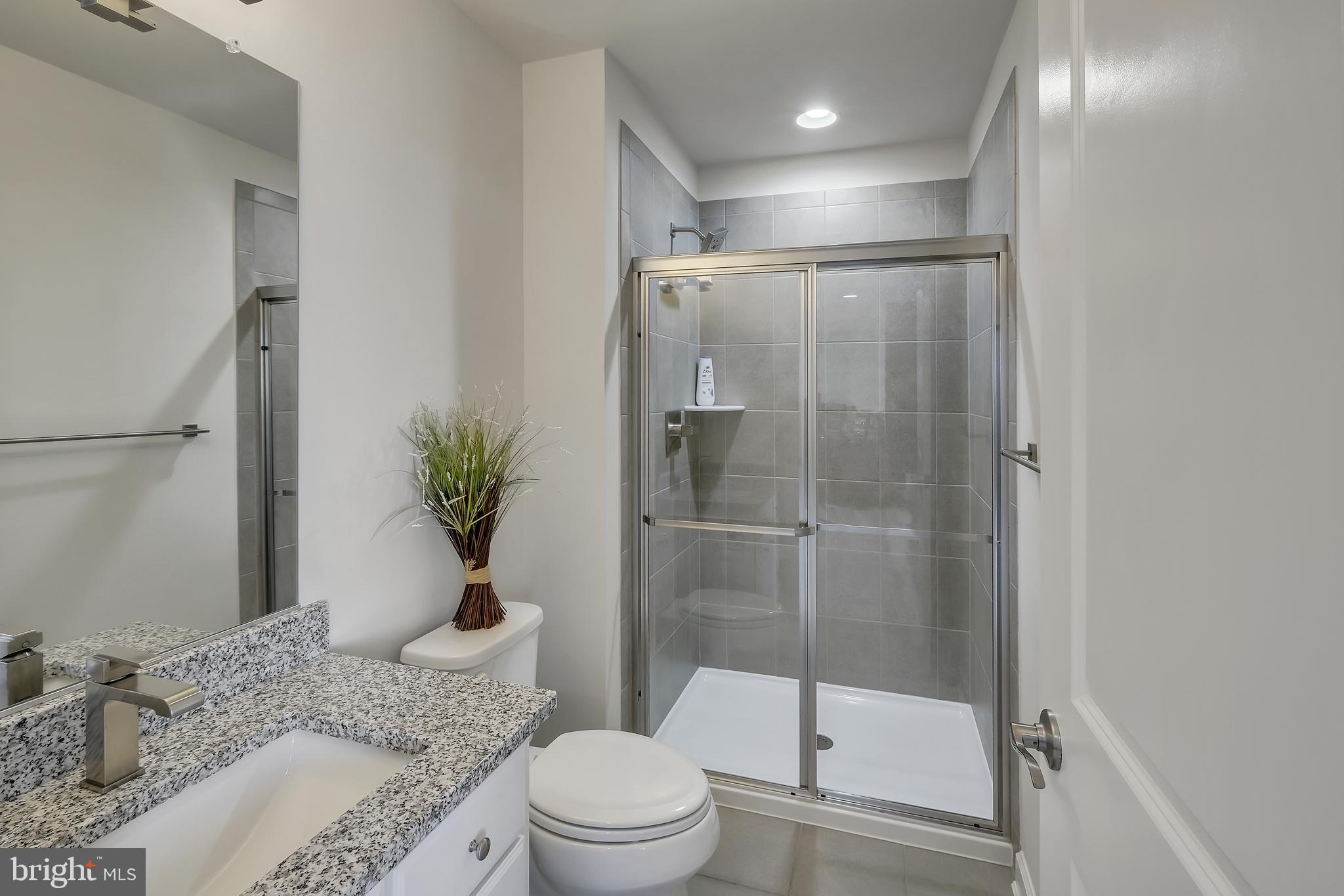 2918 Middleham Court Hanover, MD 21076 - Photo 25 of 37 a bathroom with a granite countertop sink toilet and shower