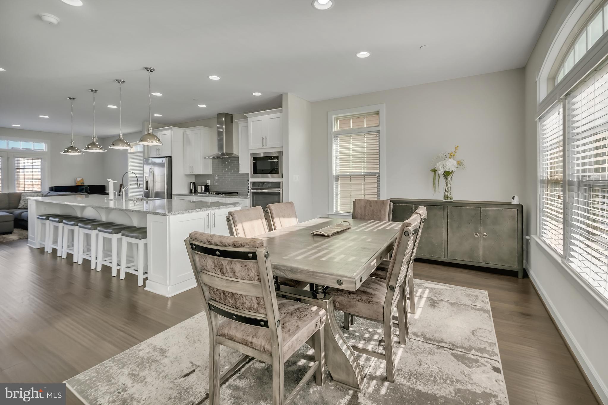 2918 Middleham Court Hanover, MD 21076 - Photo 3 of 37 a dining hall with stainless steel appliances granite countertop a stove a table and chairs