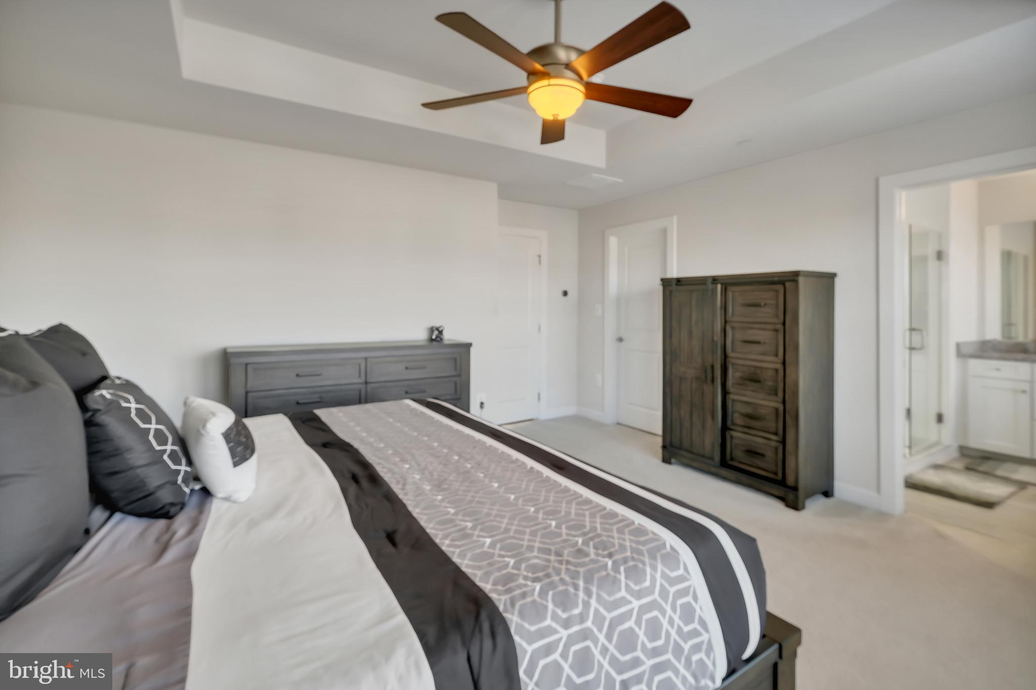 2918 Middleham Court Hanover, MD 21076 - Photo 4 of 37 a bedroom with a bed and a chandelier