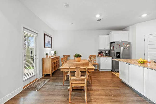 a open kitchen with white cabinets and stainless steel appliances
