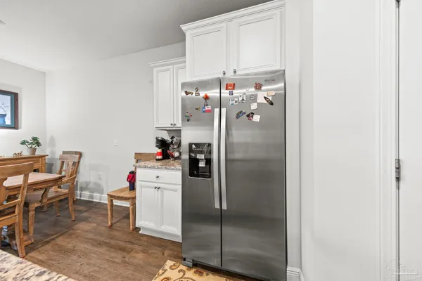 a kitchen with refrigerator and cabinets