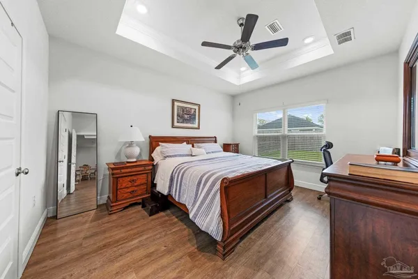 a bed room with a bed and a chandelier