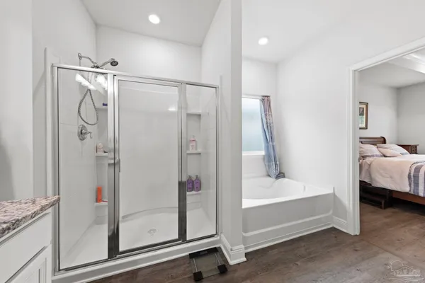 a bathroom with a tub and a shower