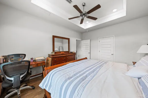a bedroom with a bed and a chandelier