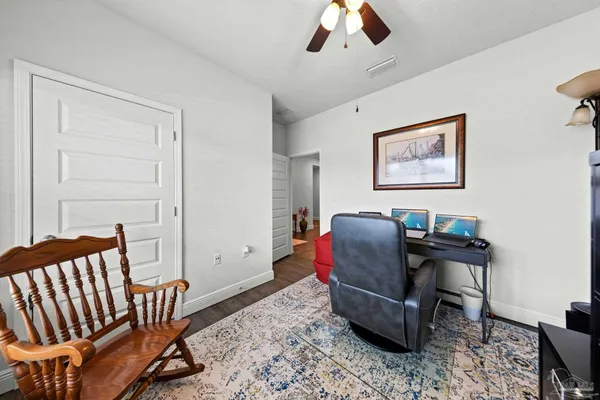 a work room with furniture and wooden floor