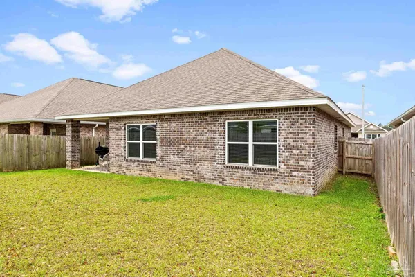a view of a house with a yard and sitting area