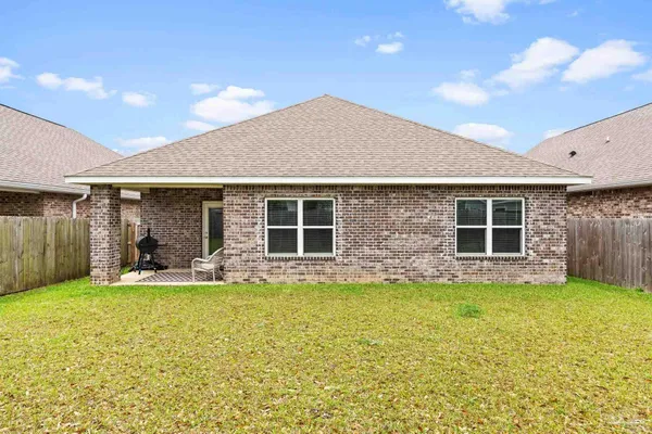 a view of a house with a yard and sitting area