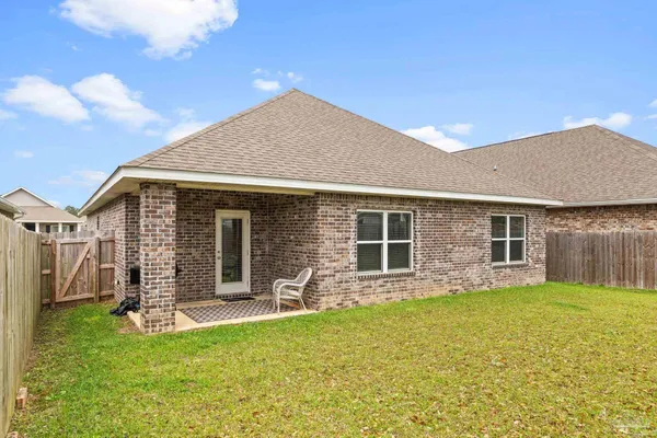 a front view of house with yard and outdoor seating