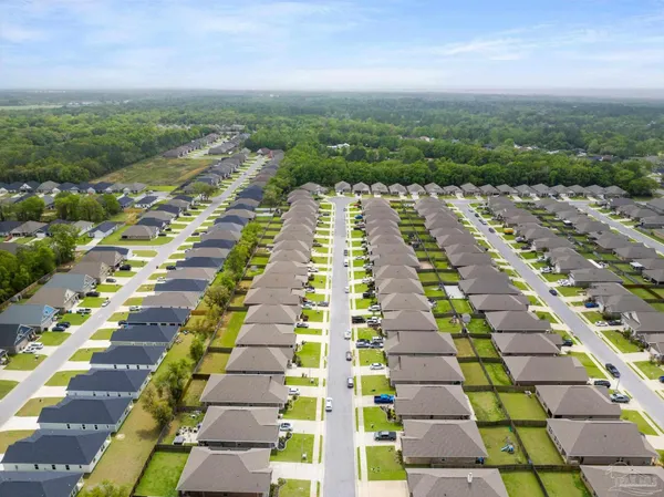 an aerial view of residential houses with outdoor space