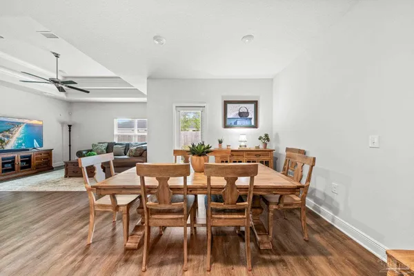a view of a dining room with furniture and wooden floor