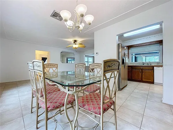 a view of a dining room with furniture and chandelier
