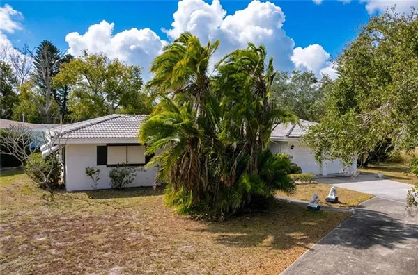 a view of a house with a yard and sitting area