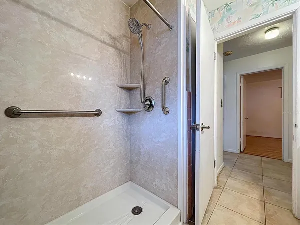 a bathroom with a shower and a sink