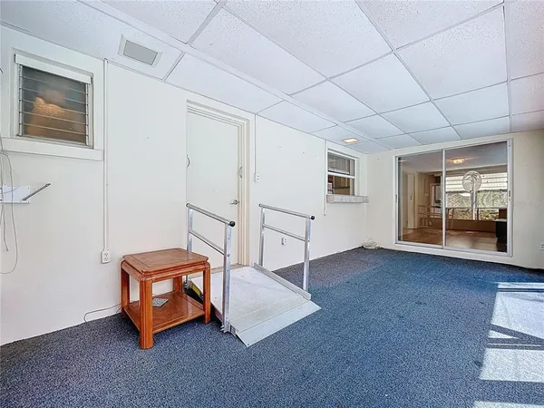 a room with pool table and window