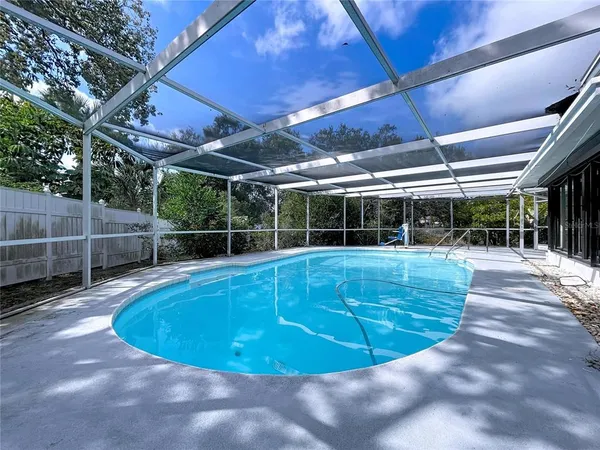 a view of a swimming pool with a patio