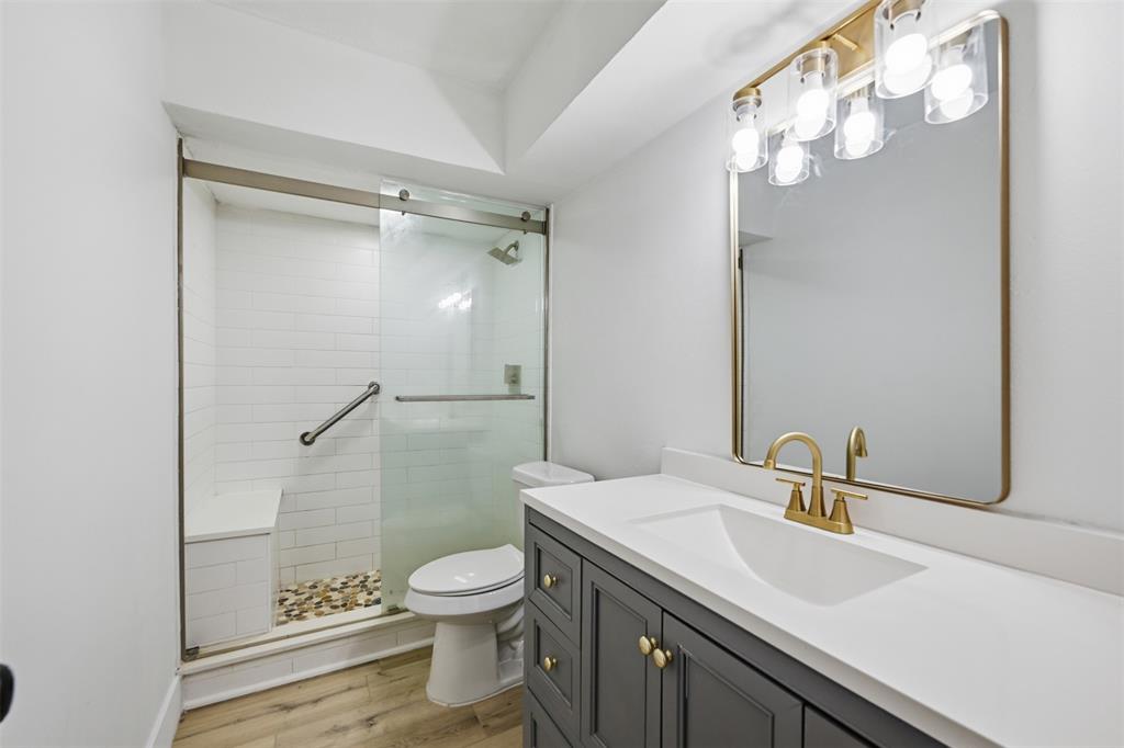 3308 Rufus Street Fort Worth, TX 76119 - Photo 8 of 17 Bathroom featuring a dark gray vanity with a white countertop and a rectangular undermount sink