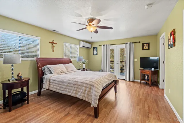 a bedroom with a bed and wooden floor