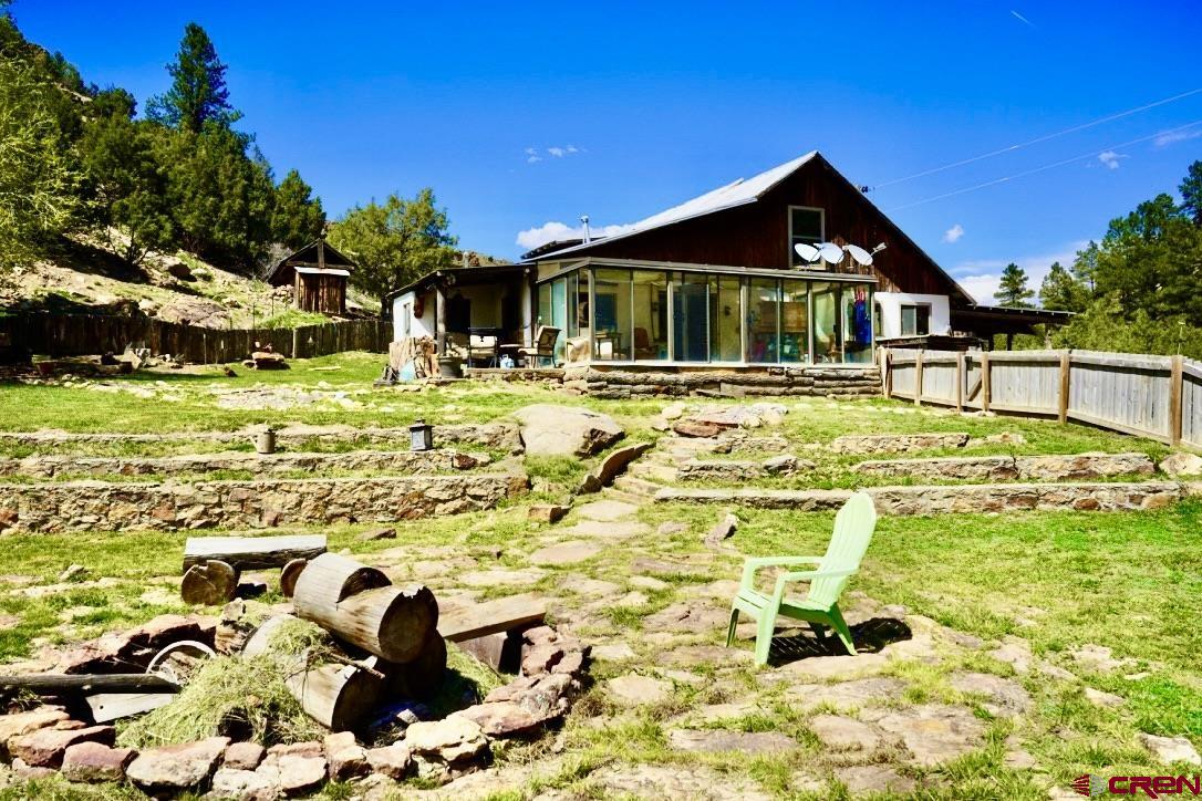 955 County Road 303, Unit CROSS CANYON RANCH Cebolla, NM 87518 - Photo 21 of 44 a front view of house with outdoor seating